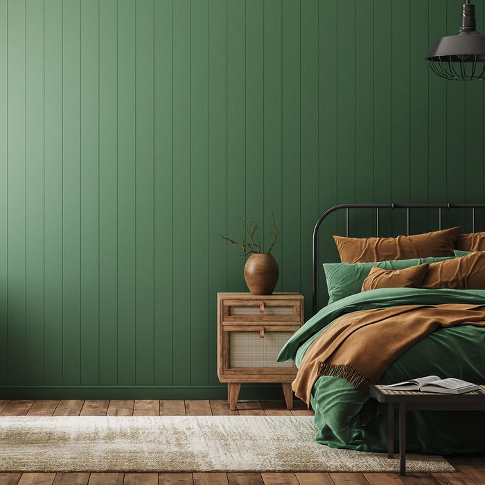 Bedroom interior in farmhouse style in rich greens and browns