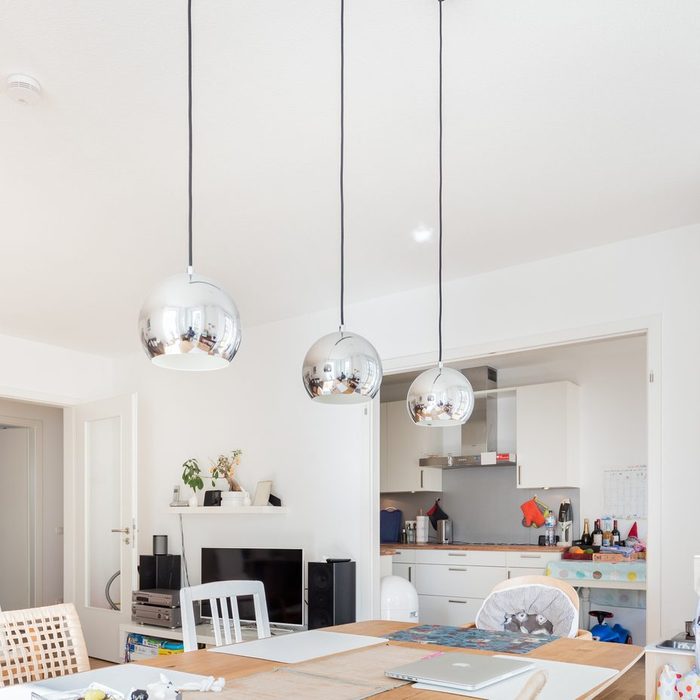 dinning room and small kitchen with modern hanging lights