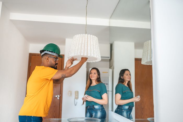 Electrician changing lamp