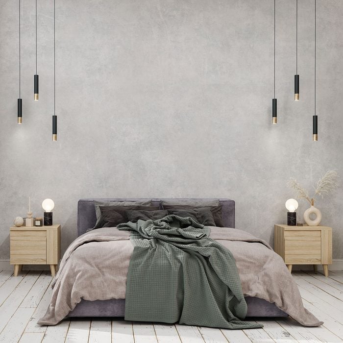 Bedroom Interior With Green Blanket On The Bed, Pendant Lights, Parquet Floor And Gray Color Wall Background