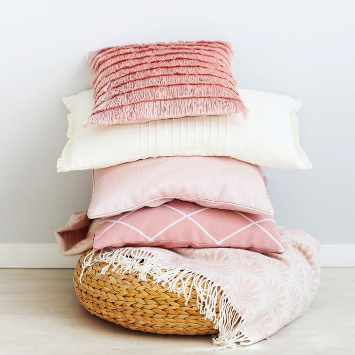 Pink And White Pillows On The Wall Background