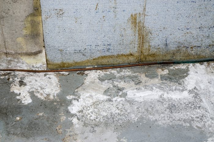 Basement concrete floor full of efflorescence because of humidity