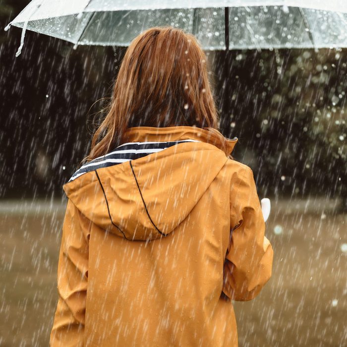 Female walking during rain outside