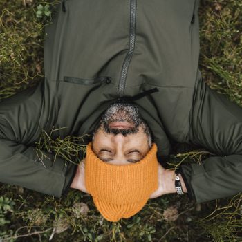 Directly above shot of man lying down on land in forest
