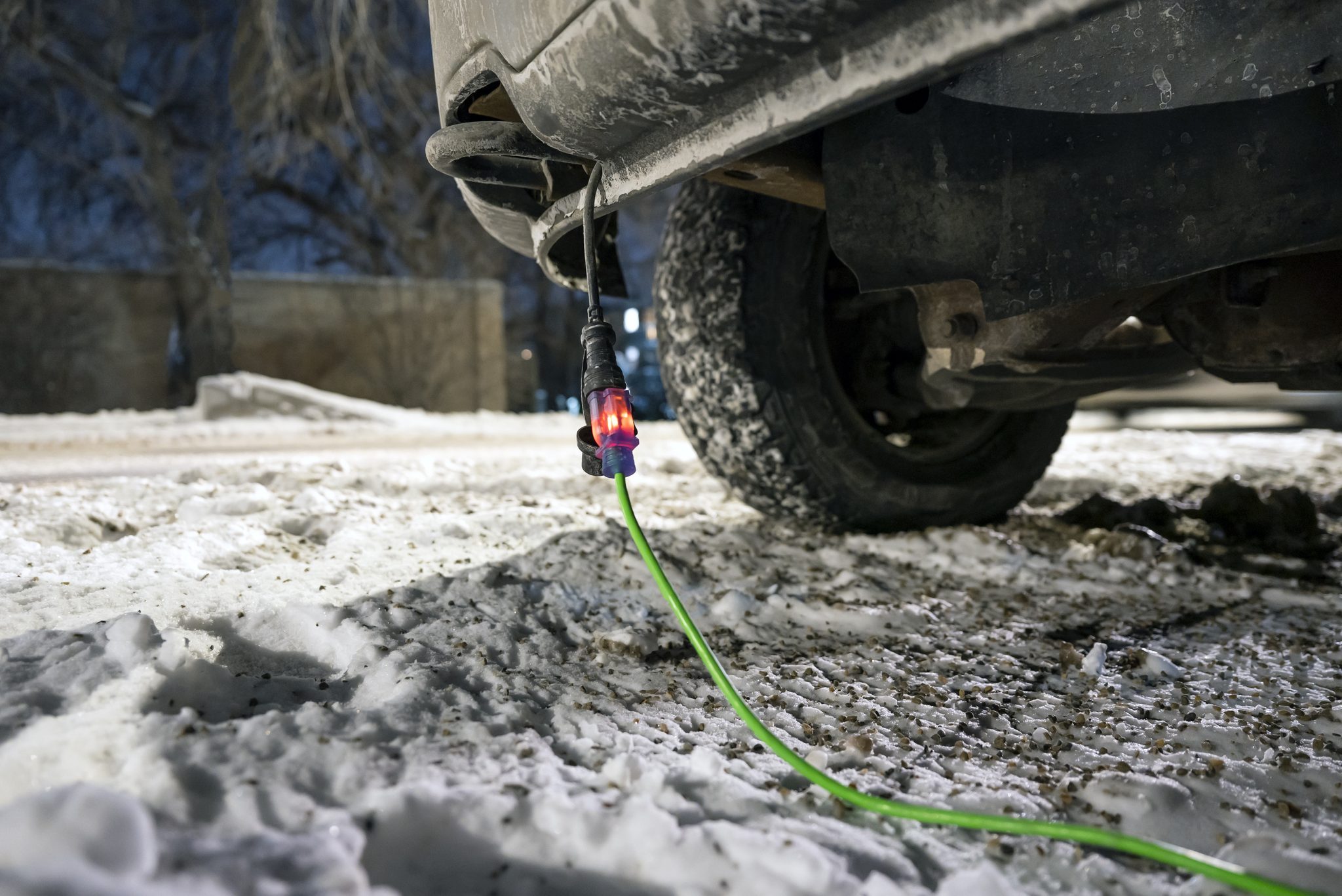 Extension cord plugged into vehicle in winter