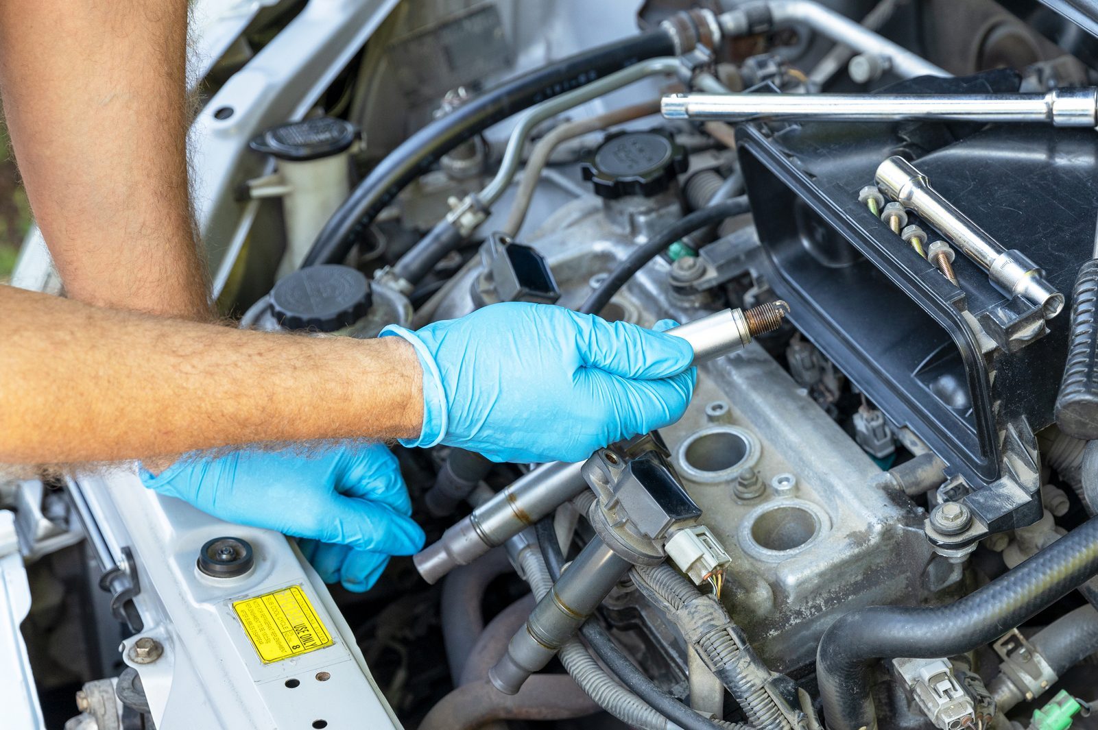 Misfiring car spark plug replacement and repairing of vehicle at home