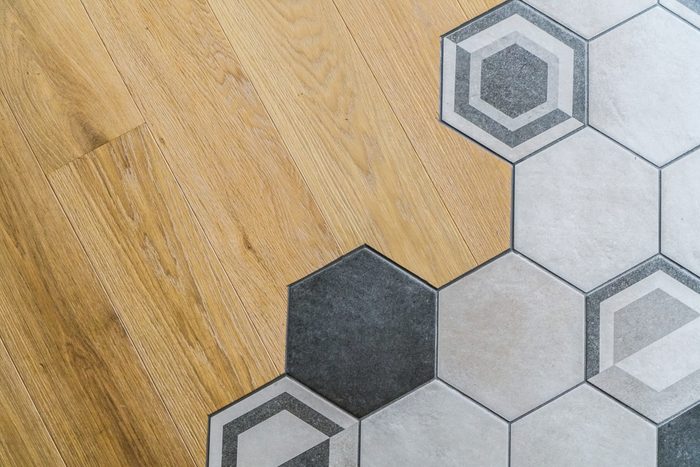 Wooden Parquet Floor Mixes with Grey Honeycomb Tiles
