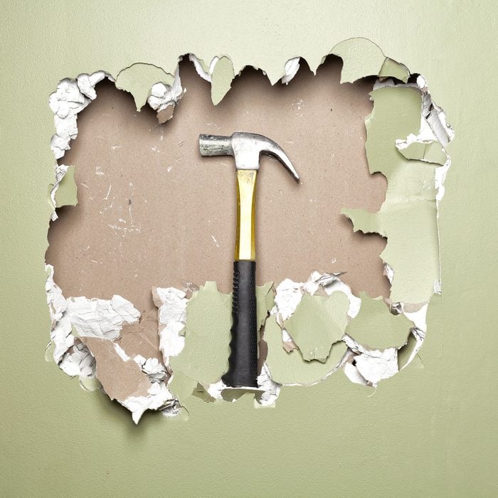 Green Wall Broken with Hammer in hole