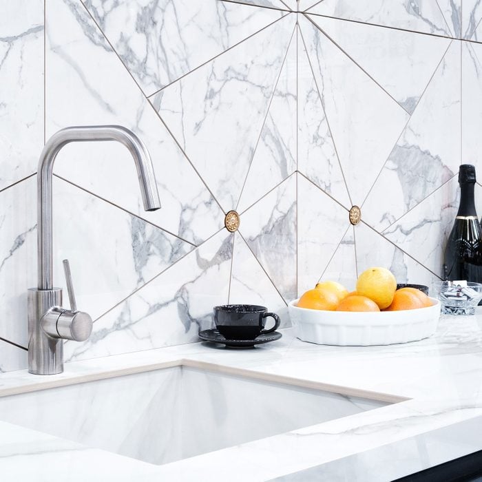 Modern Kitchen with Granite Backsplash a graystone countertop and a luxury washbasin