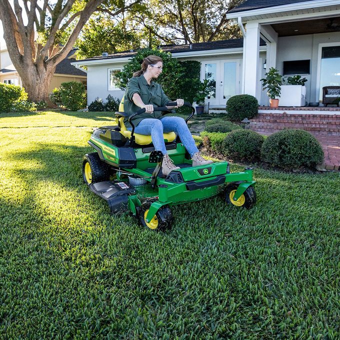 John Deere Ztrak 370r First electric Mower with Woman mowing the lawn