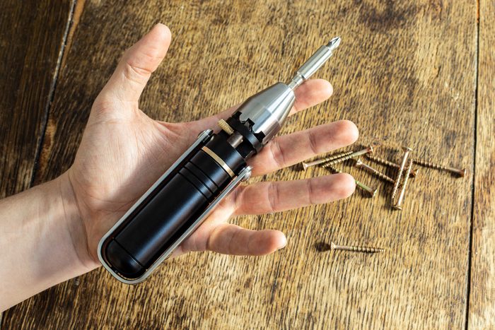 Metmo Driver With Screws and drill bits on a wooden background courtesy MetMo