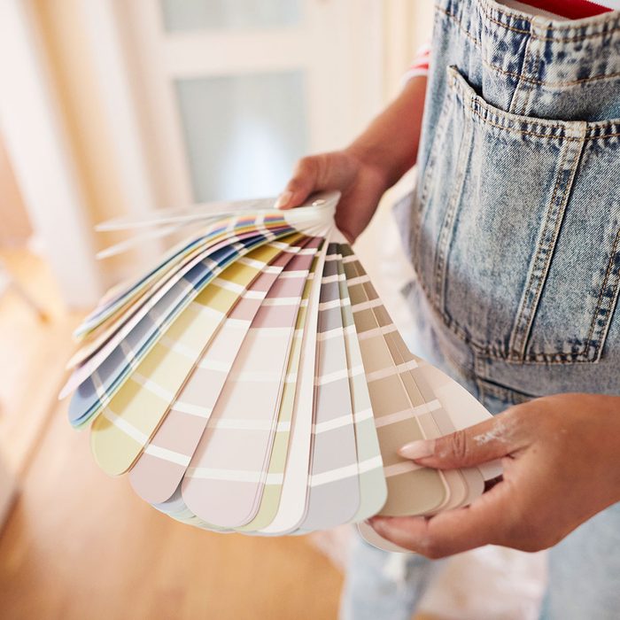 Woman Choosing Paint Color During Home Renovation