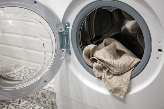 Towel hanging out of a washing machine