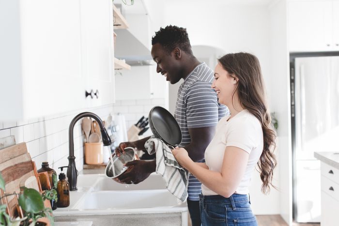 Young Couple doing Dishes in Bright Kitchen
