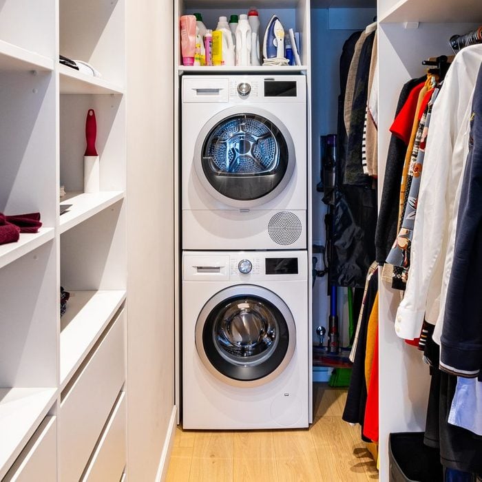 closet with washer dryer stacked