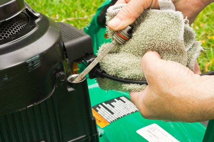 checking oil on a lawn mower