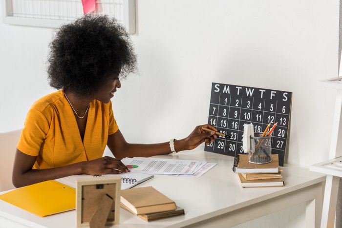 young african american freelancer checking calendar at workplace at home office