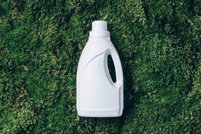 White Plastic Bottle Of Cleaning Product Household Chemicals Or Liquid Laundry Detergent On Green Grass Moss Background Top View Flat Lay Copy Space Detergent Bottle
