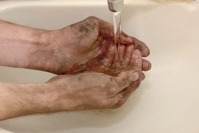 Man Washes Dirty Hands After Working Outdoors