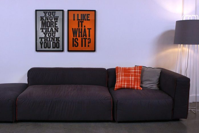 Prints by British graphic artist Anthony Burrill hang over "Kleon", an overstuffed modular sofa at Blu Dot, a new design store in the Mission in San Francisco, California on Thursday, August 29, 2013.