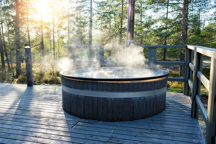 Modern big barrel outdoor hot tub in the middle of forest