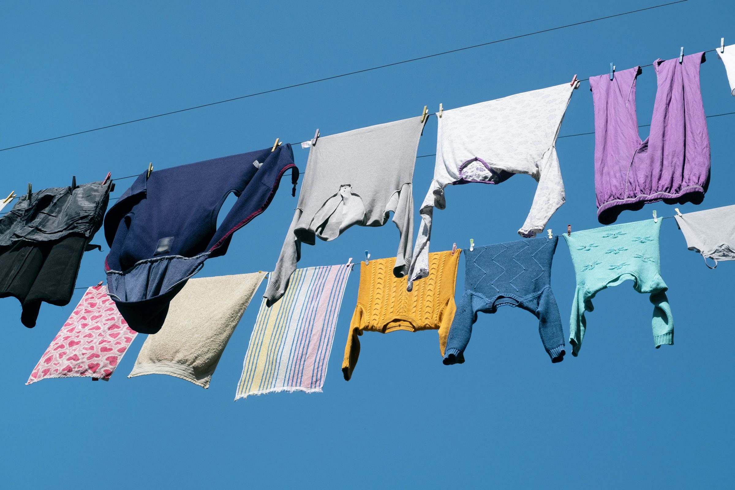 Clothes Line with clothes drying against the blue sky