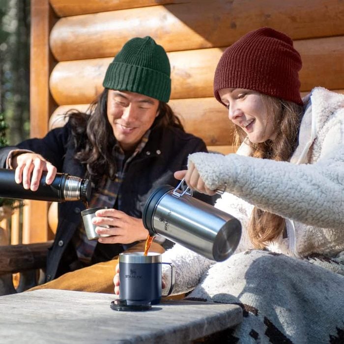 two people having coffee using the Stanley’s Outdoor Coffee Brewer for Camping