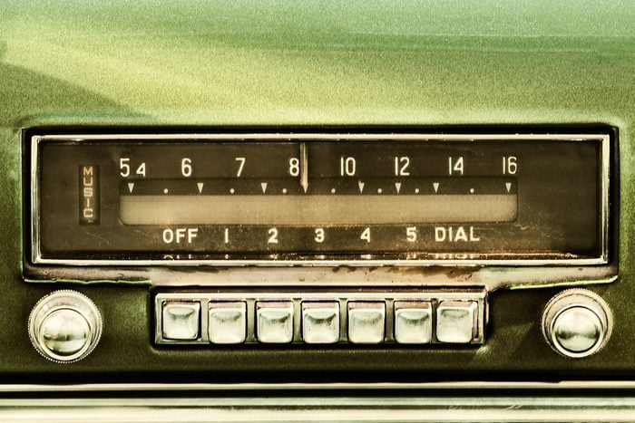 Old car radio and dials inside a green classic car