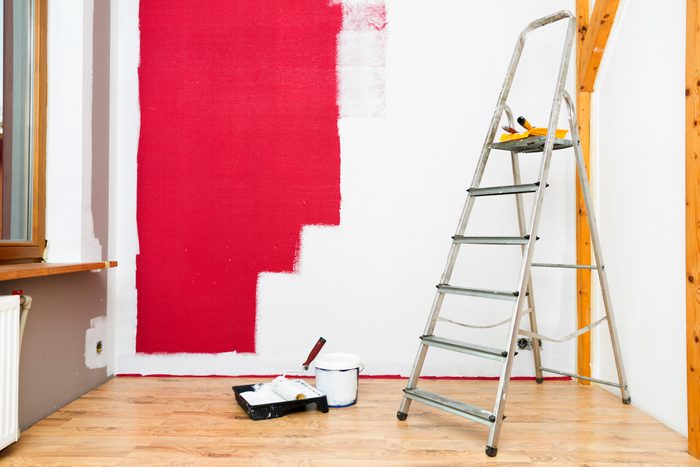 painting over a red painted wall with white