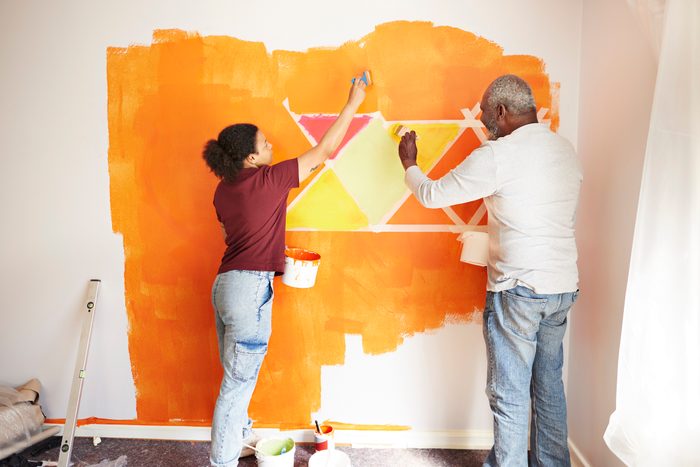 Family painting design on wall at home