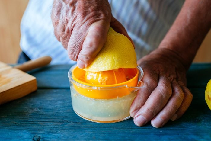 Close-up of hands squeezing lemon