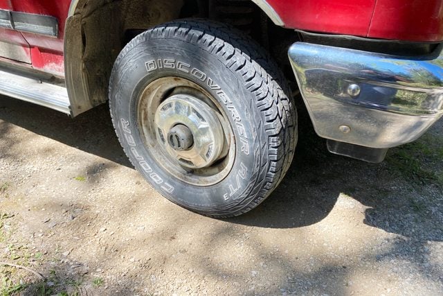 using a vehicle to drive over the newly filled pot hole