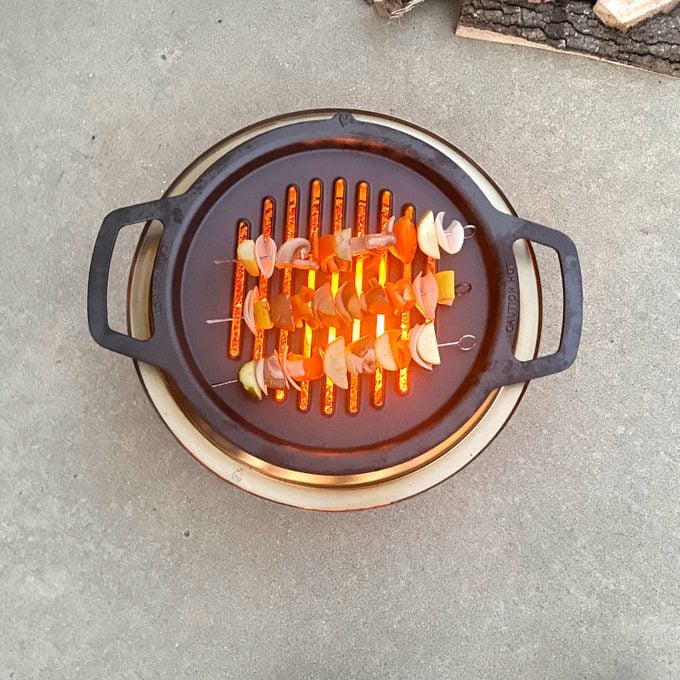Grilling kabobs on a Solo Stove Ranger Cast Iron Grill Top