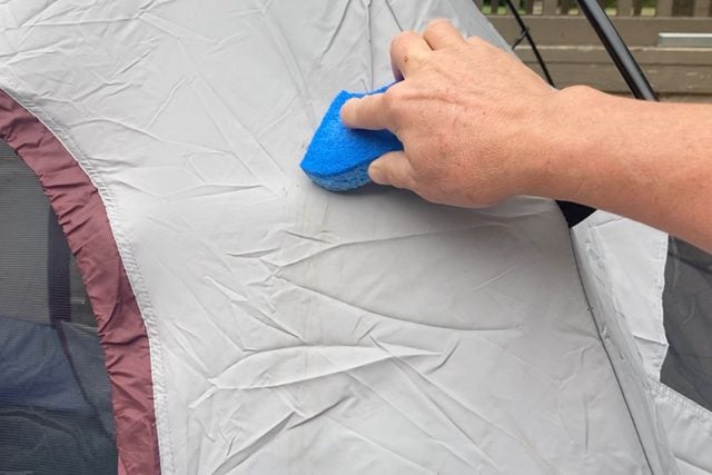 scrubbing tent with a blue sponge