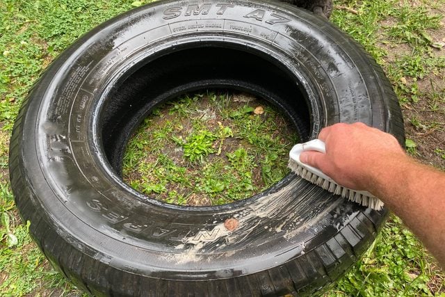 cleaning a tire with a brush