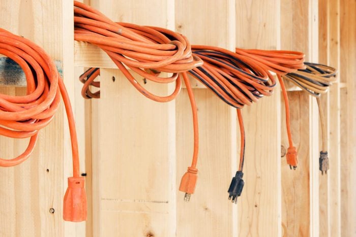 Extension Cords resting on wooden wall studs