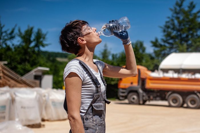 Thirsty Female Blue-collar Worker in Ore Processing Plant