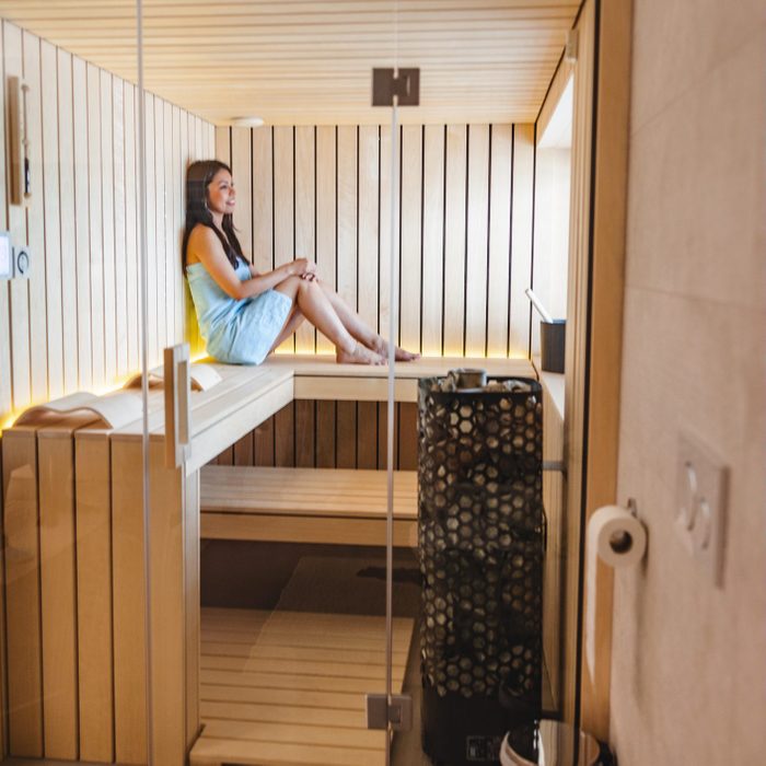 Adult Caucasian Female Relaxing Alone In A Small Wooden Home Sauna