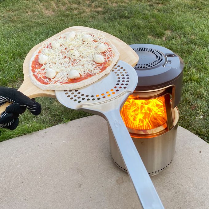 putting a pizza in the Solo Stove Pi Fire