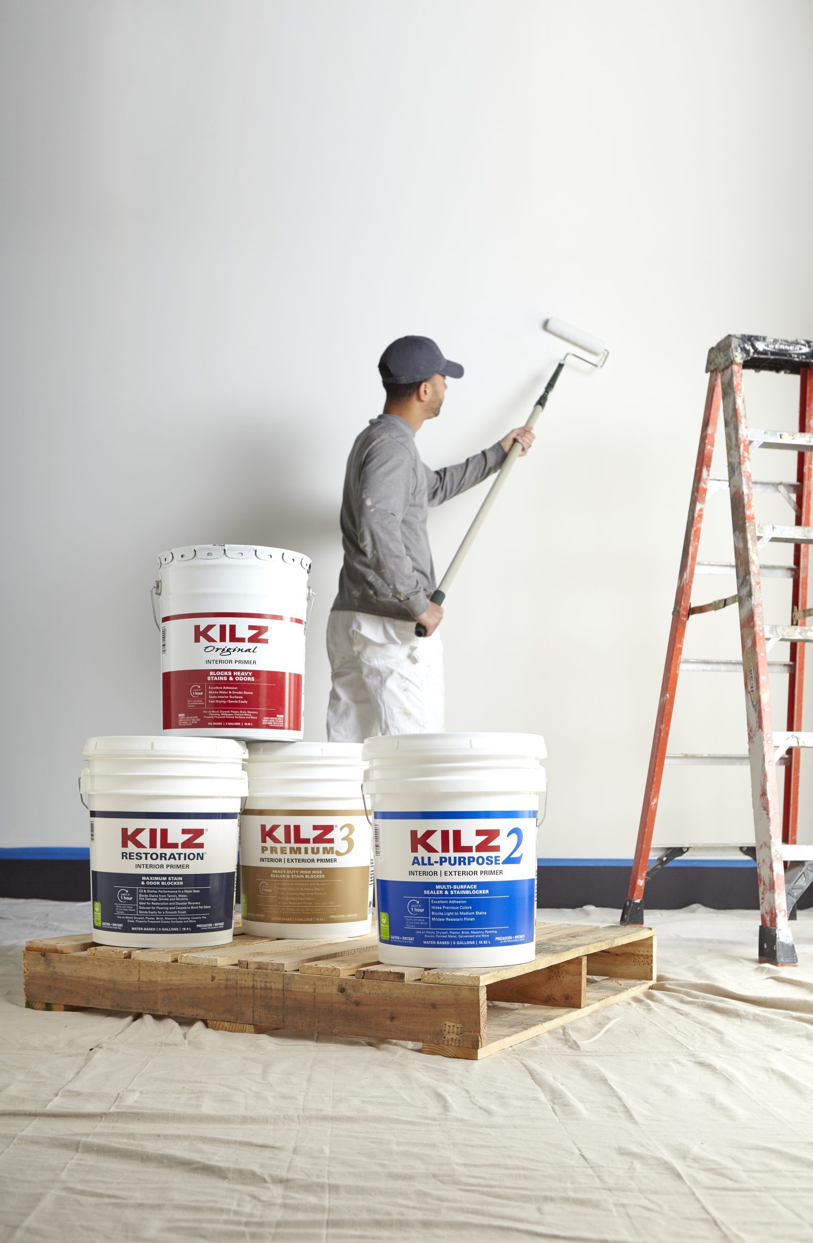 Man painting wall with KILZ