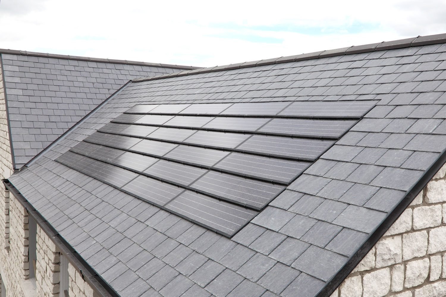 A new set of solar panels which blend in nicely with a black tiled roof.