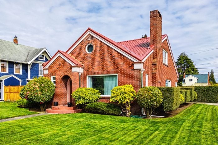 Small Red Brick House with Green Grass