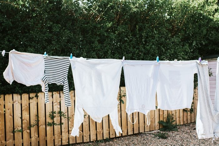 Clothes Line outside with white clothes drying in the summer time