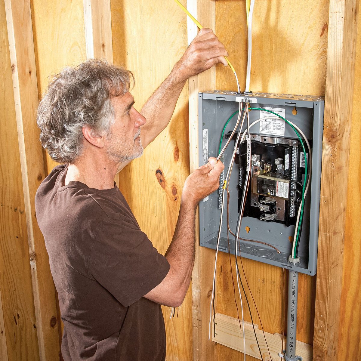Man Fixing Wiring of Garage Subpanel