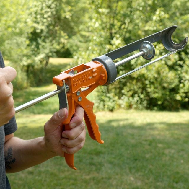 Pulling the L shaped rod of caulk gun