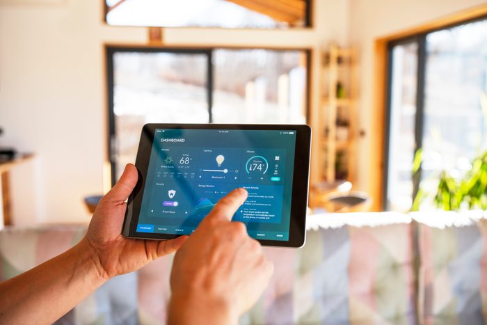 Man using tablet with smart home control functions at home