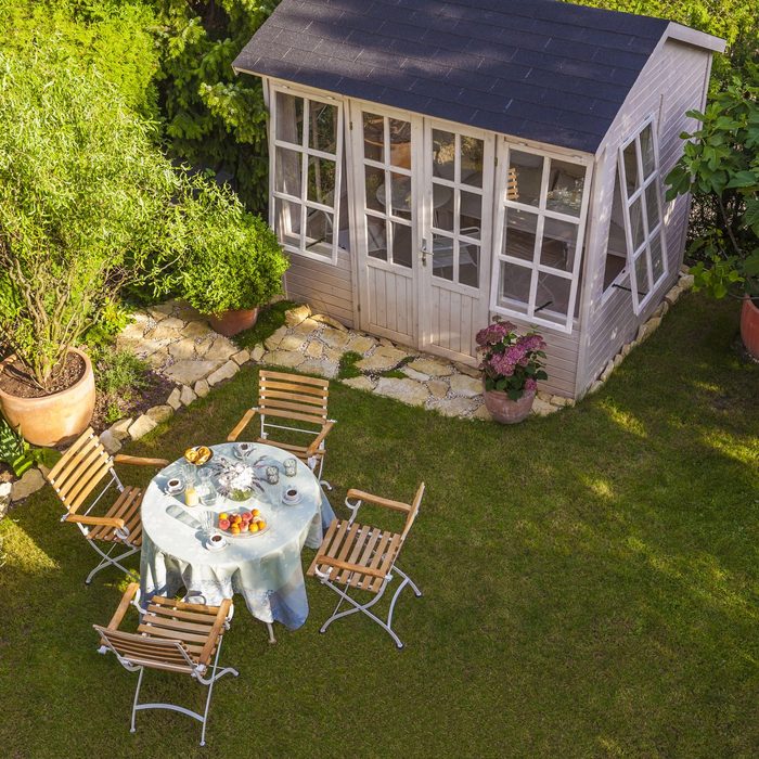 Garden shed and laid table in garden