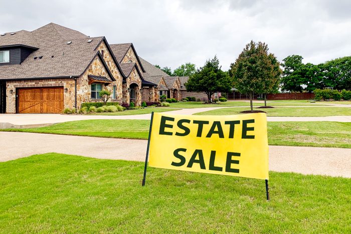 Estate Sale sign in front of a large