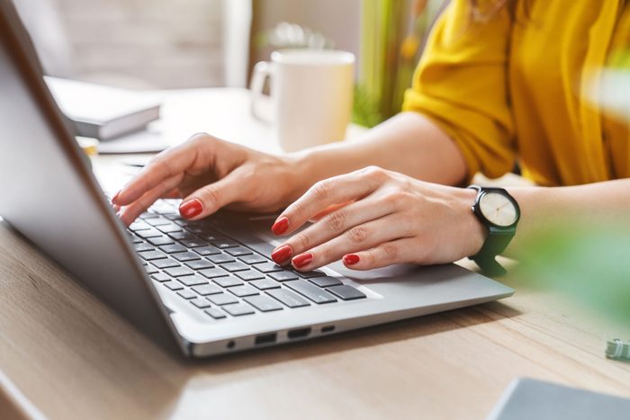 Cropped Image Of Business Woman Hand Working Laptop Computer In Home Office
