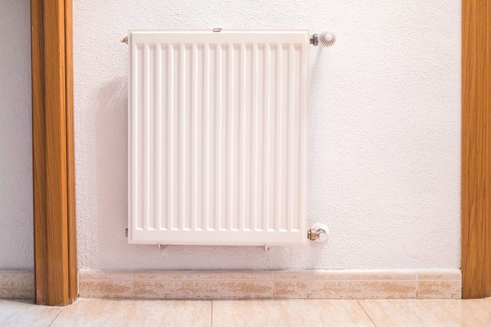 White iron central heating radiator inside a house